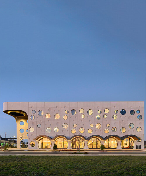 playful, circular windows punctuate buchan's library expressive facade in australia