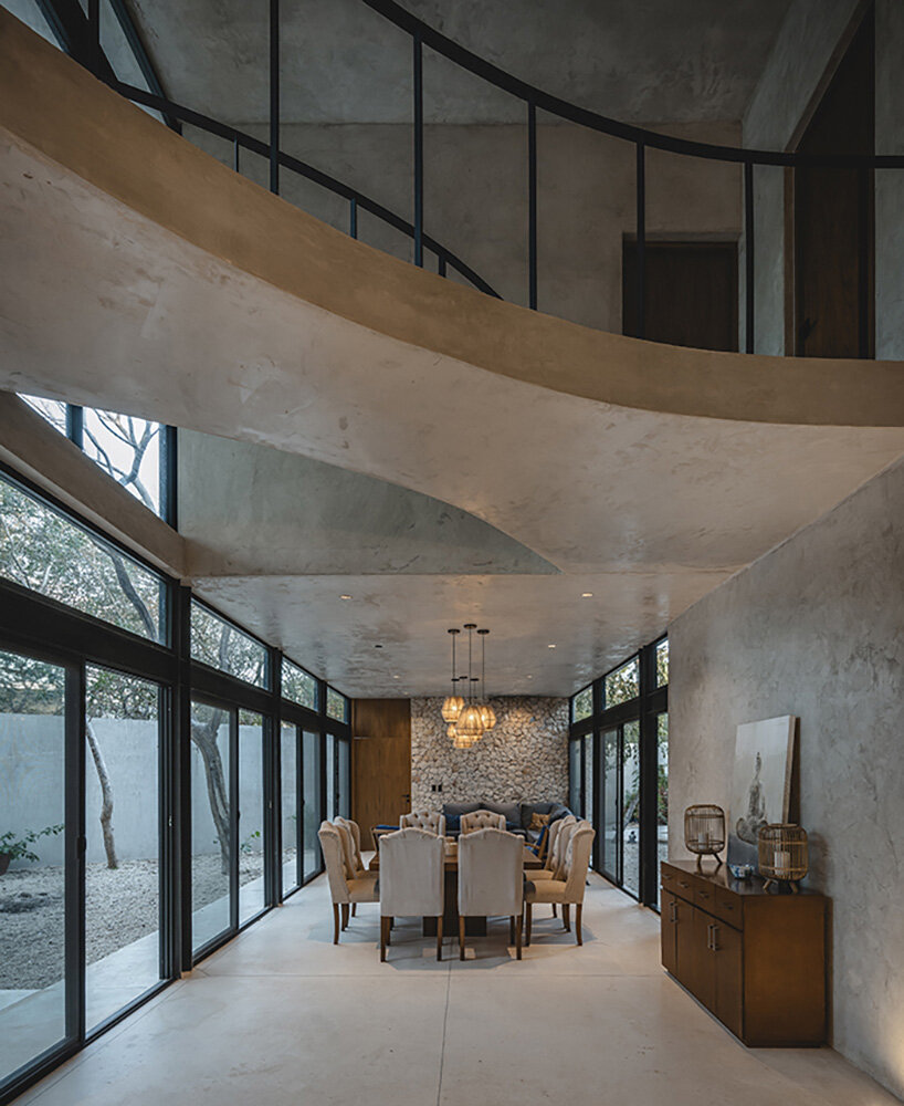 concrete residence with integrated yoga studio weaves around yucatan's endemic trees
