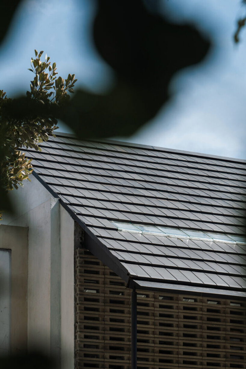 interlocking spaces behind perforated brick facade turn home into an office by dhanie & sal in indonesia