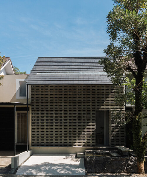 interlocking spaces behind perforated brick facade turn home into office in indonesia