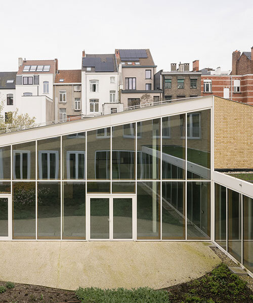 evr-architecten's new brick-clad office building envelops glazed green patio in belgium