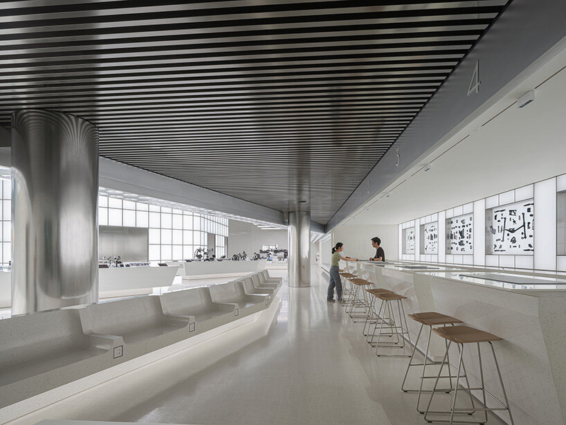 faceted glass curtain walls flood DJI's shenzhen origami-like flagship store with sunlight