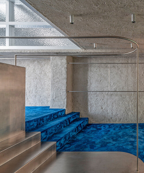 continuous blue carpet evokes coastal spain within raúl sánchez's store interior in ibiza