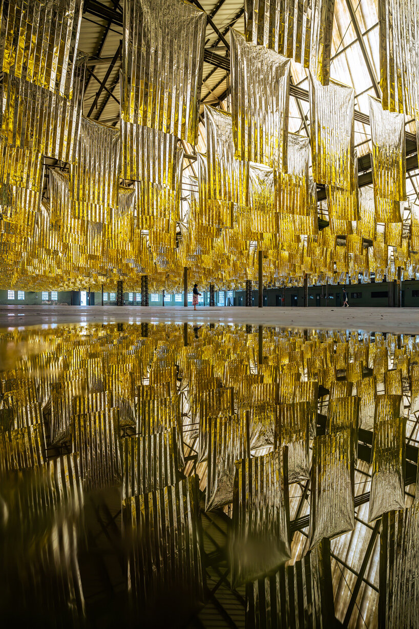 reflective sea of salvage blankets by SpY whispers inside former oviedo weapons factory