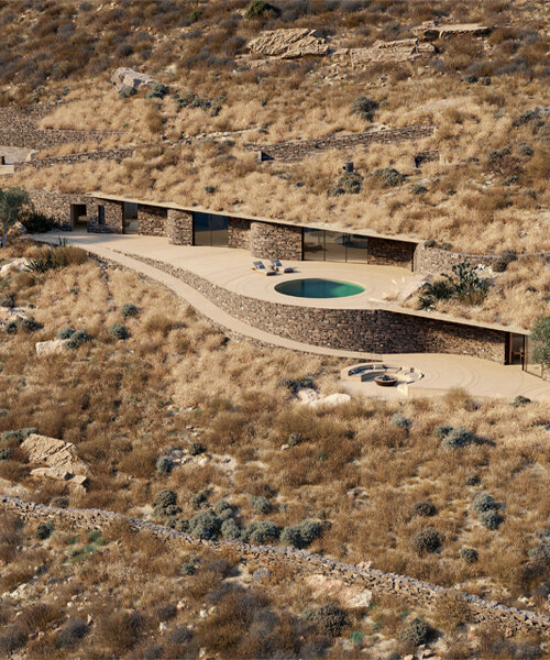 stone-clad rhoēs villa by sinas architects emerges like water ripples on serifos island