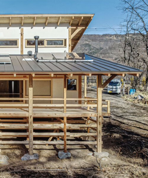 sobokuya rests wooden home on stone foundation near mount yatsugatake in japan