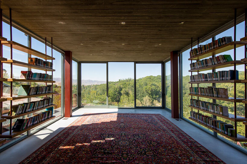 suspended bookshelves float within villa's glazed volume by ayeneh office in tehran