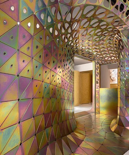 thousands of galvanized steel petals shape prismatic installation within gallery in shanghai