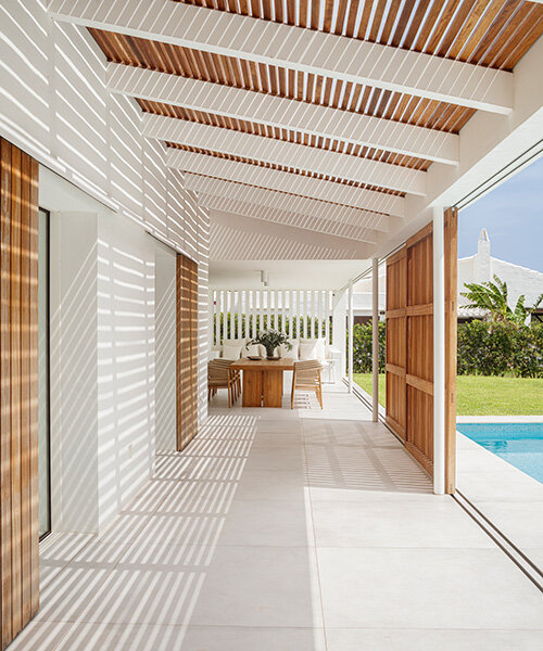 E+E house: architect gabriel montañés frames menorca coast through sliding timber shutters