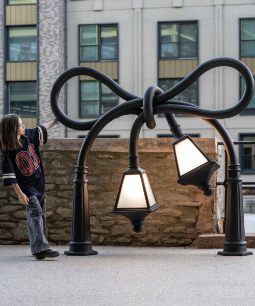 alex chinneck knots street lamps and twists a phone booth for his assembly bristol sculptures