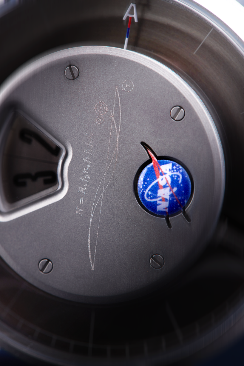 detailed view of the NASA meatball logo as well as the Drake Equation and Water Hole radio emission lines