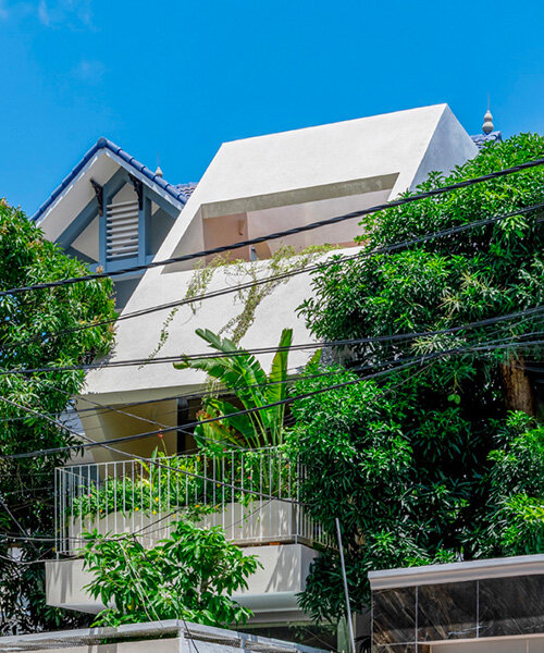 cutouts in slanted concrete roof illuminate vietnamese residence by DMA architects