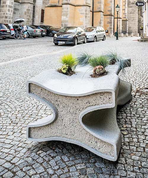 concrete bench X doubles as a planter, reflecting czech republic's gothic heritage