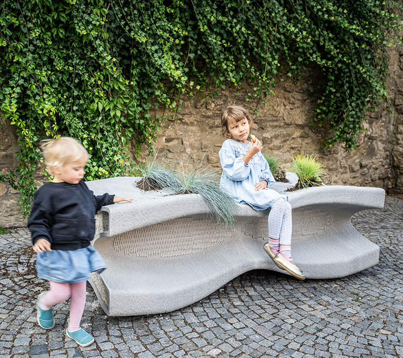 concrete bench X doubles as a planter, reflecting czech republic's gothic heritage