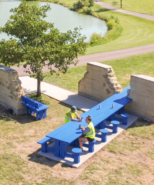 picnic table and bench intersect i/thee's eroded rammed earth walls in iowa park