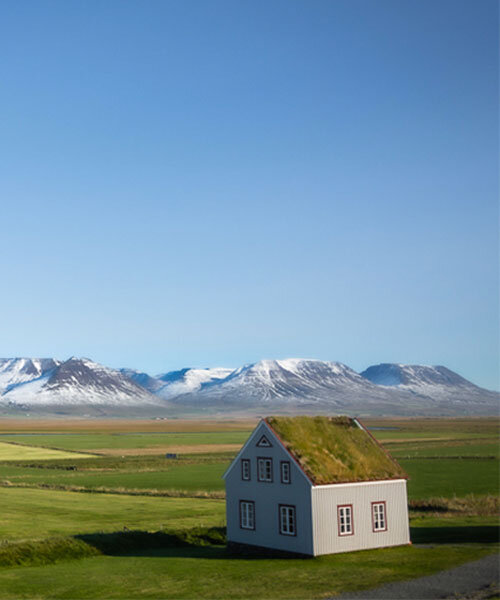 curro cardenal's photo series captures isolated homes scattered onto iceland's rugged land