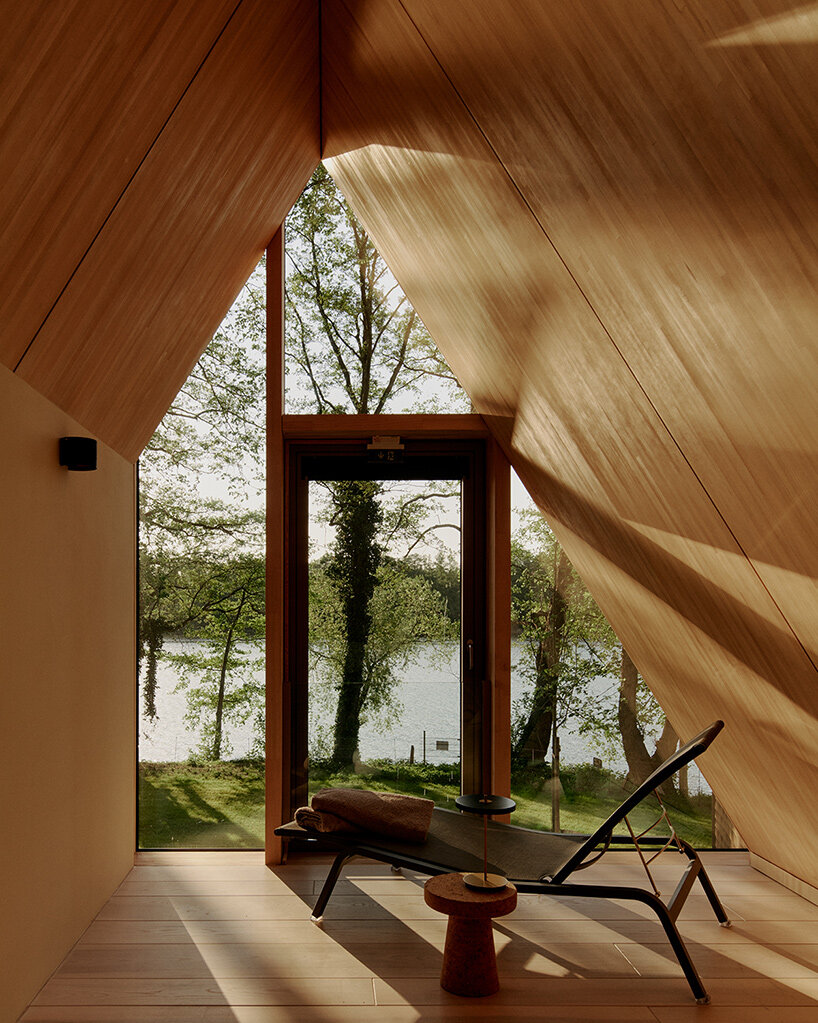 sigurd larsen staggers timber volumes to frame lake views outside berlin