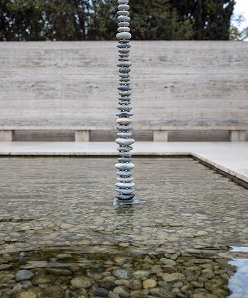 levitating pebble installation defies gravity at mies van der rohe's barcelona pavilion