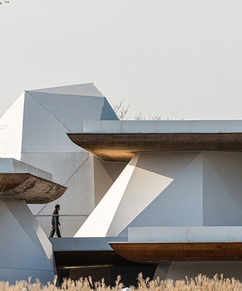 twelve rock-like tents by line+ brace layered steel platforms floating above mountains