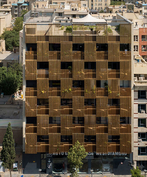 vertically laid wooden blinds screen sarv office building's interiors in tehran