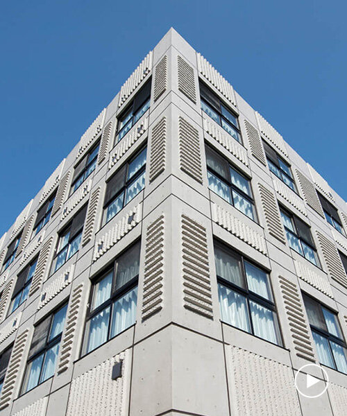 textured concrete facade envelops living facility center in japan by SAKO architects