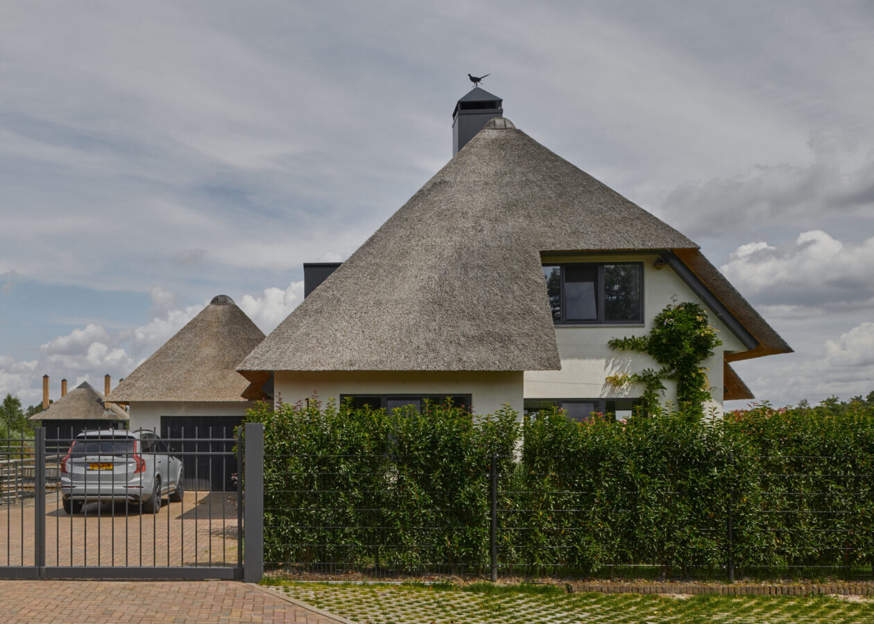 thatched-roofed boathouse addition anchors dutch villa renovation by serge schoemaker