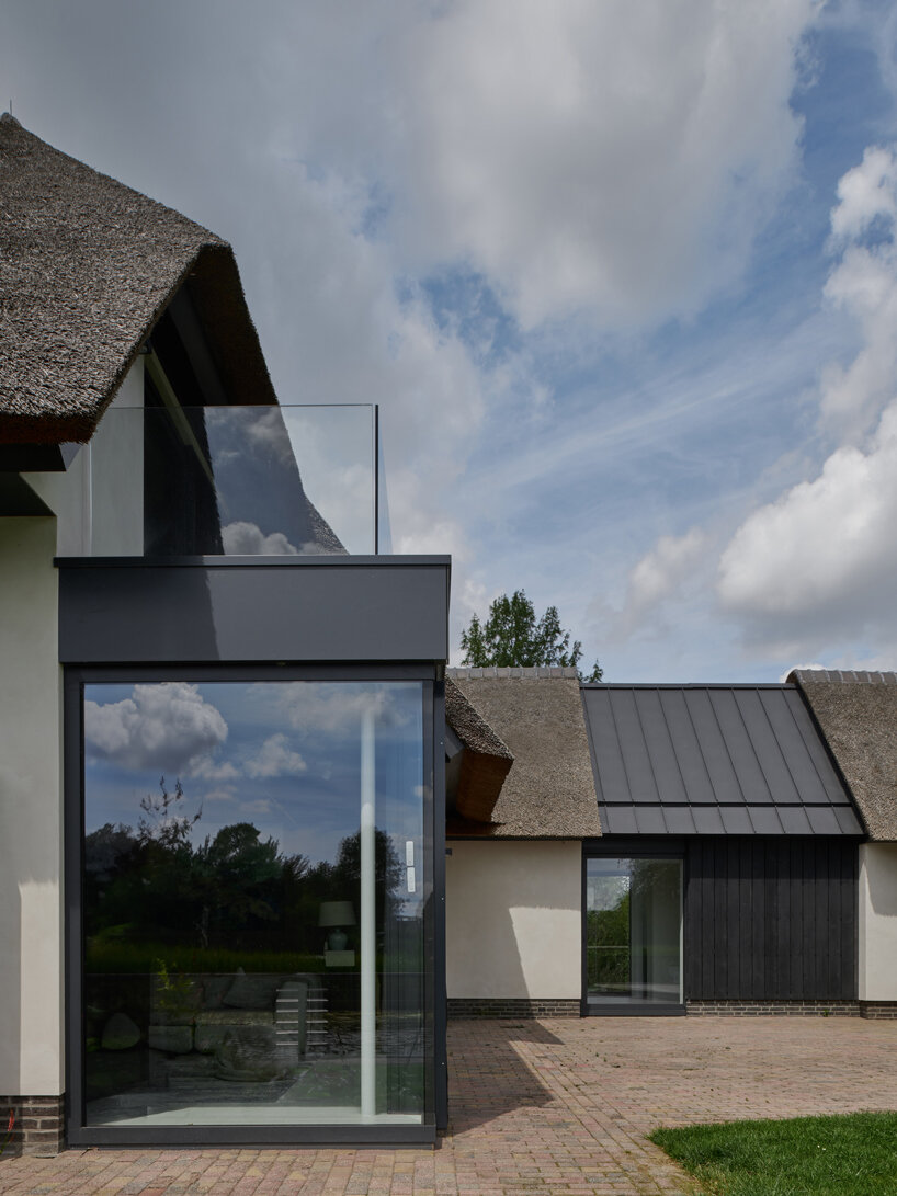thatched-roofed boathouse addition anchors dutch villa renovation by serge schoemaker