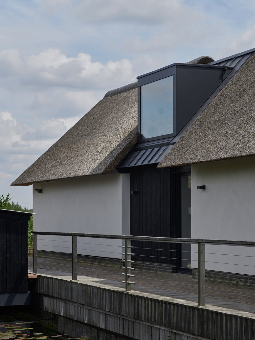 thatched-roofed boathouse addition anchors dutch villa renovation by serge schoemaker