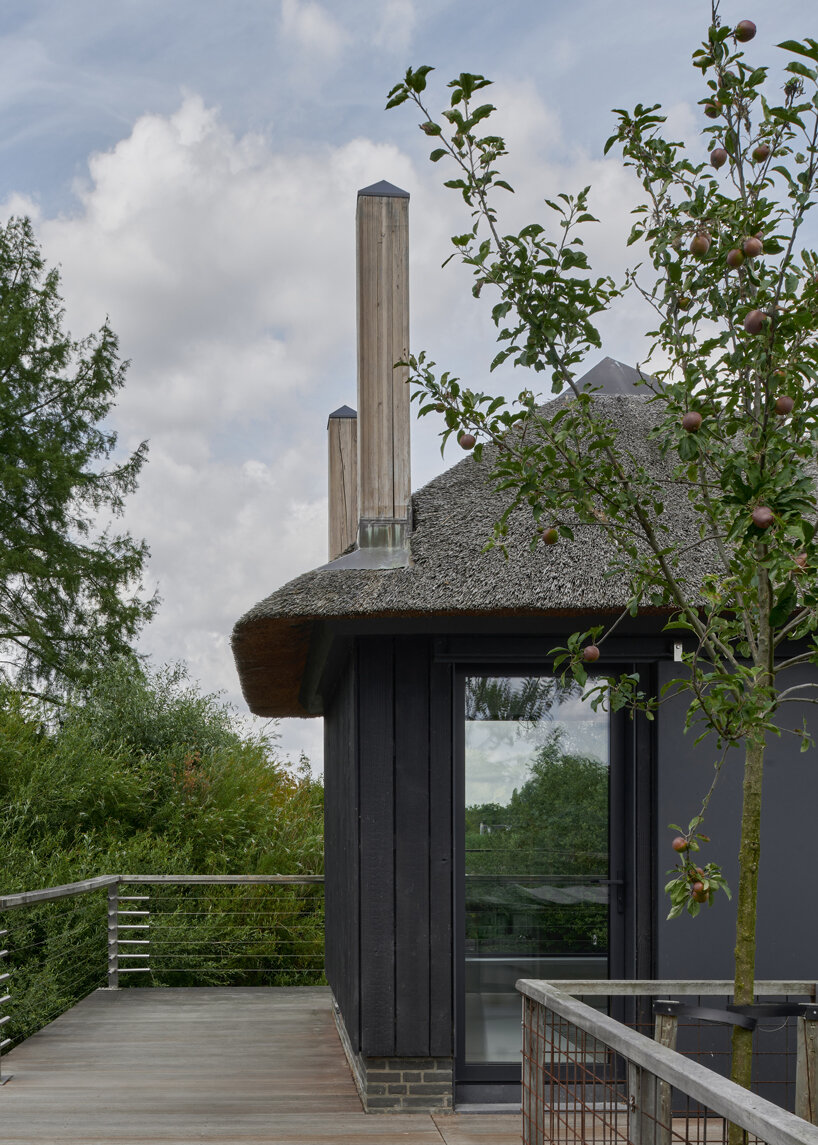 thatched-roofed boathouse addition anchors dutch villa renovation by serge schoemaker