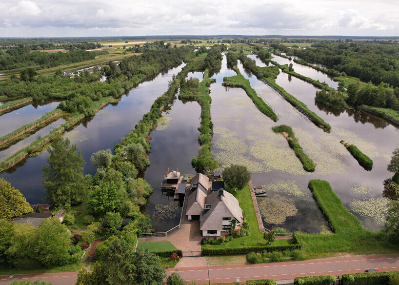 thatched-roofed boathouse addition anchors dutch villa renovation by serge schoemaker