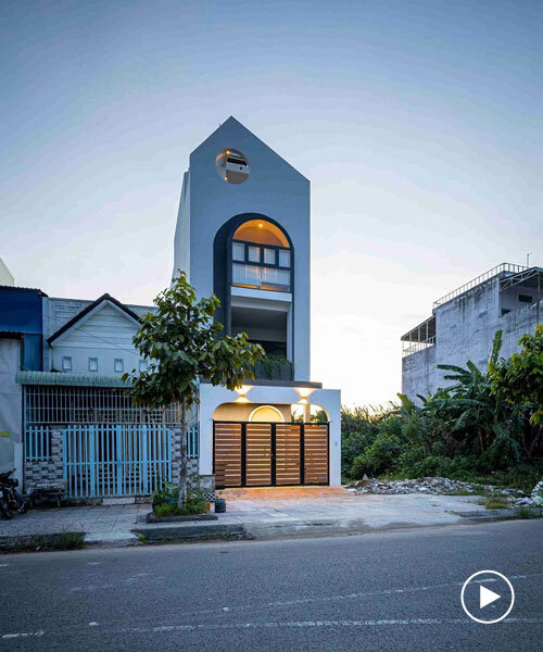 flowing lines and circles on trăng non house's facade resemble moon rising over mount fuji