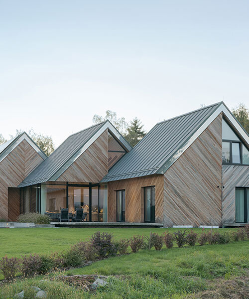 triple house by superhelix unfolds three successive gabled units clad in red cedar