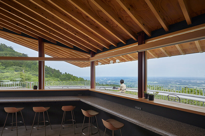 semi-circular terraces look over japanese forest park in renovation by HAGISO