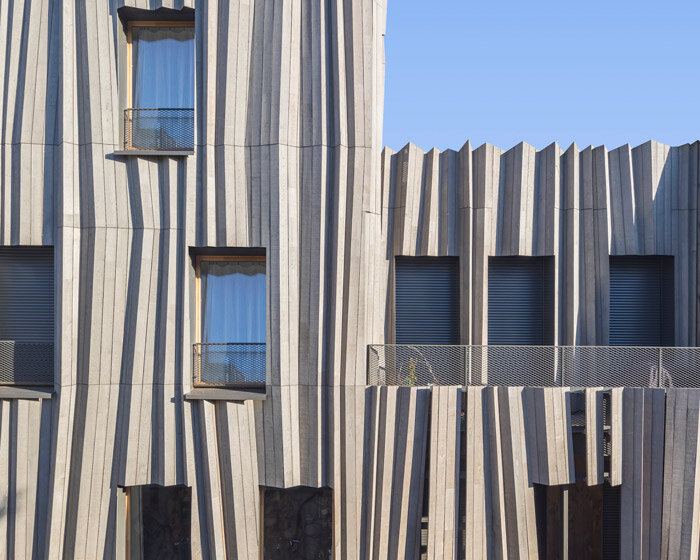 kengo kuma drapes parisian residential building 'yama-tani' in fluidly pleated timber