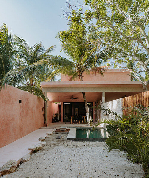 yucatan's palm trees pierce through duplex-style residential complex by proyecciones civiles