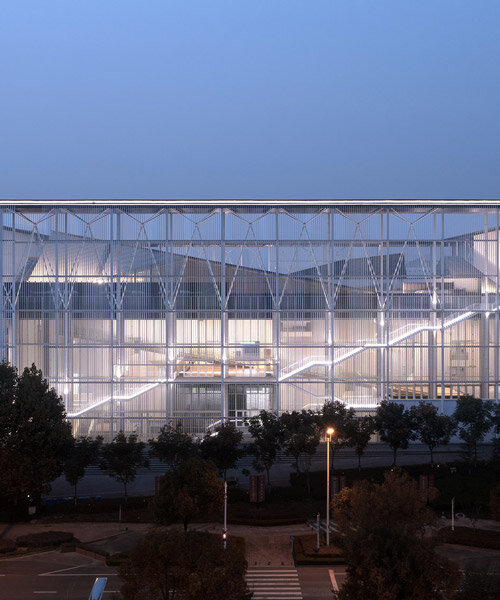 anhui art museum glows behind ethereal, transparent facade in hefei, china