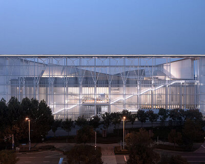 anhui art museum glows behind ethereal, transparent facade in hefei, china
