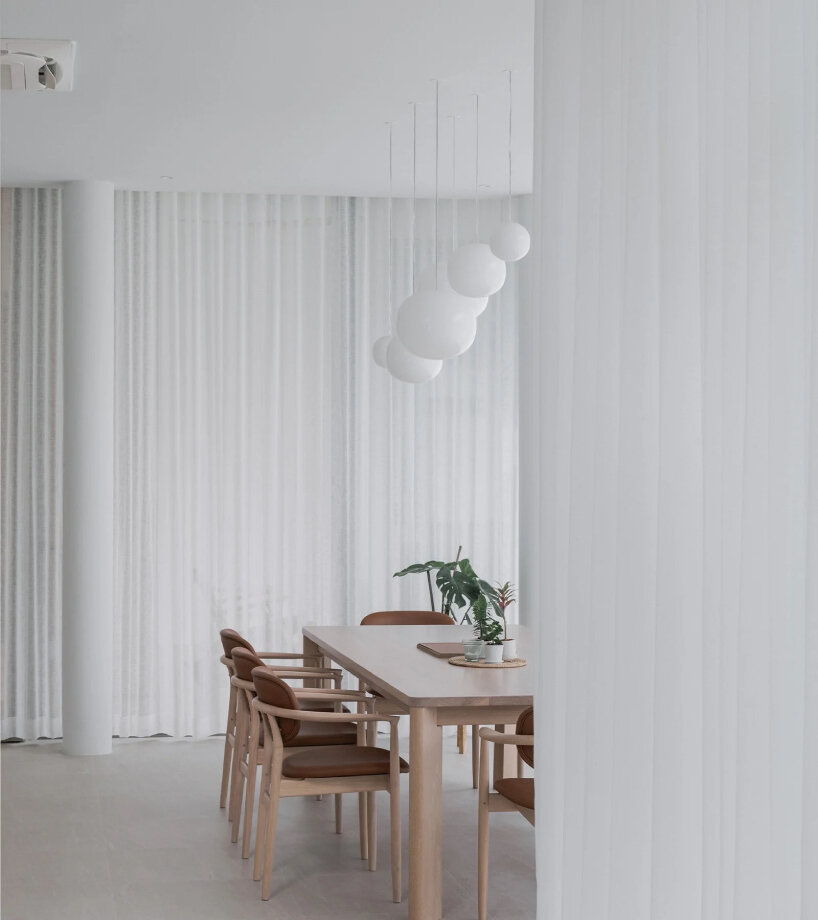 anonym studio's all-white house in bangkok adopts scandinavian minimalism