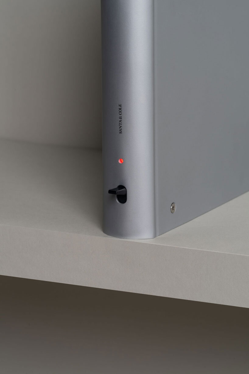 shaped like a book, oscar tusquets' bib luz lamp discreetly integrates into any shelf