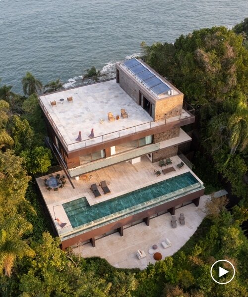 FCstudio's coastal house stacks steel, glass, & stone layers amid são paulo's rugged terrain