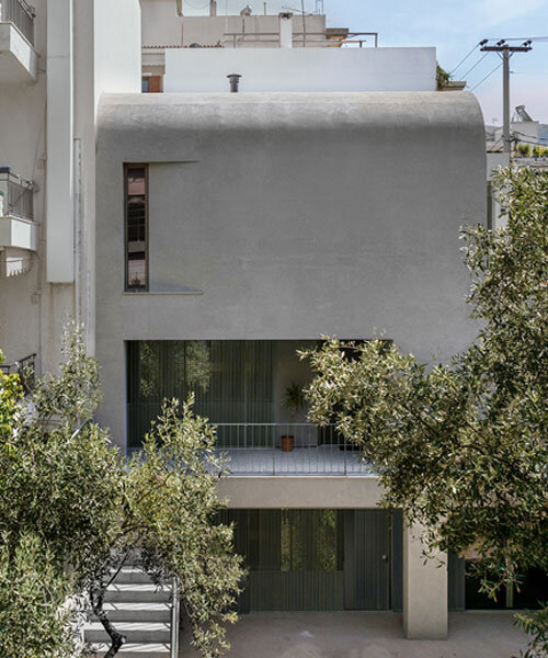 solid concrete facade shields renovated low-rise casa d's garden in athens