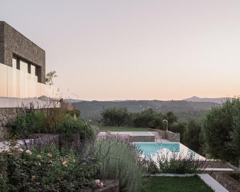 wrapped in stone, corfu house by georgios apostolopoulos overlooks the sea in greece