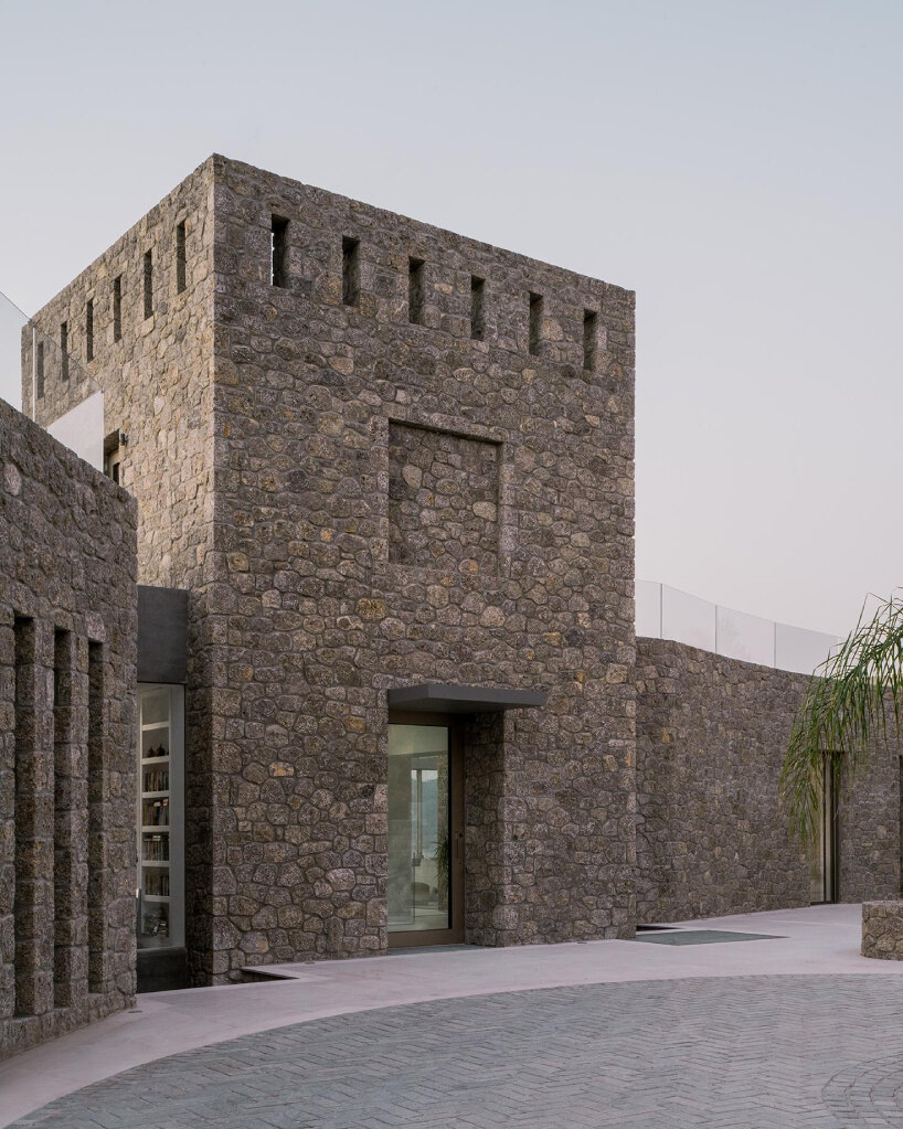 wrapped in stone, corfu house by georgios apostolopoulos overlooks the sea in greece