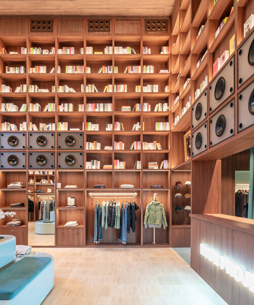 el departamento installs massive wooden bookshelf for nude project's new store in barcelona