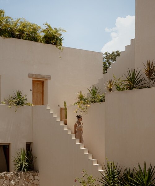 stacked chukum & stone volumes wrapped in green terraces shape RA!'s residences in tulum