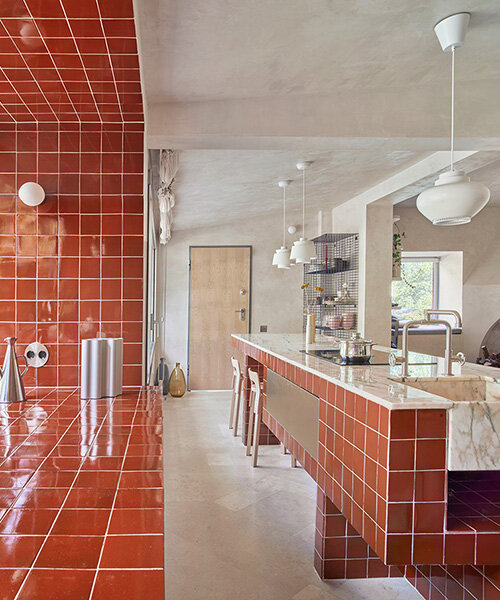 handcrafted burgundy tiles clad window frames of renovated 70s bungalow in madrid