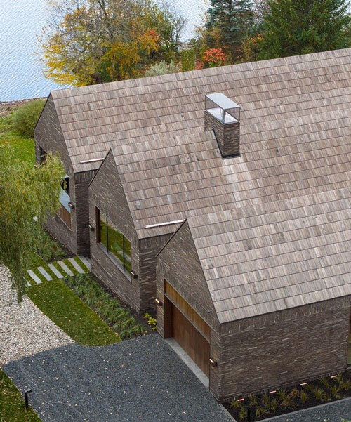 atelier échelle coats lakeside gallery residence in dark clay bricks, nodding to québec's barns