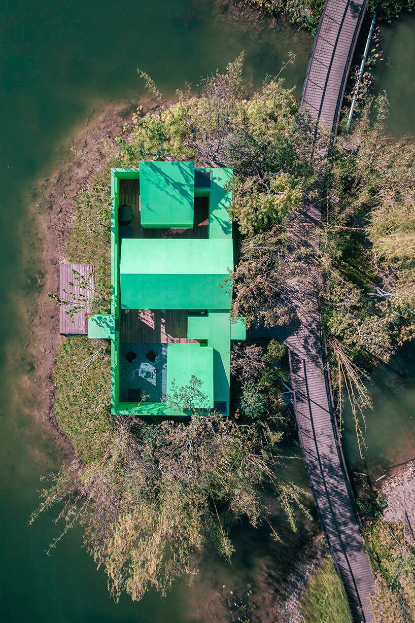 pure green cabin retreat by wiki world floats on secluded islet in chinese lake