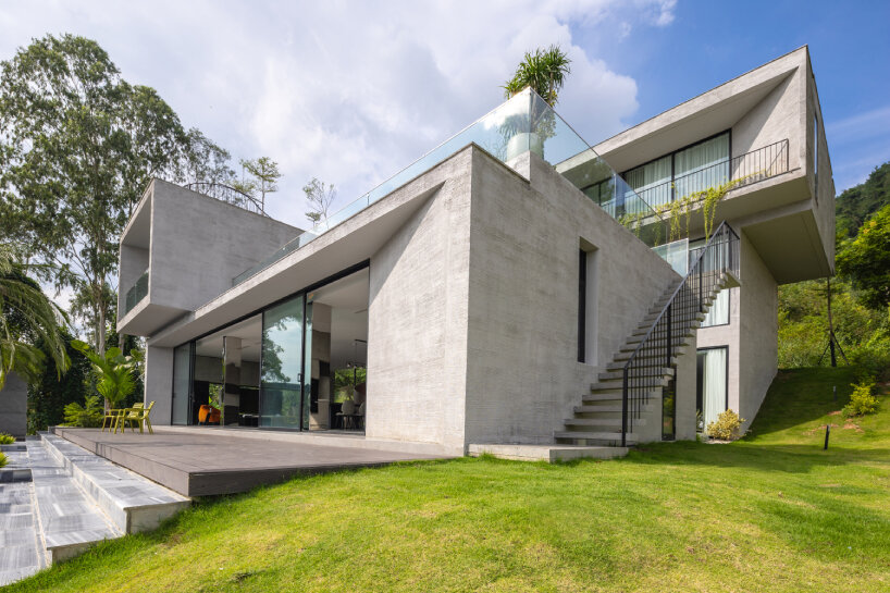 garden courtyards wind through stacked cubes of idee architects' vietnam hillside house