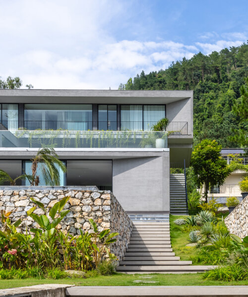 garden courtyards wind through stacked cubes of idee architects' vietnam hillside house